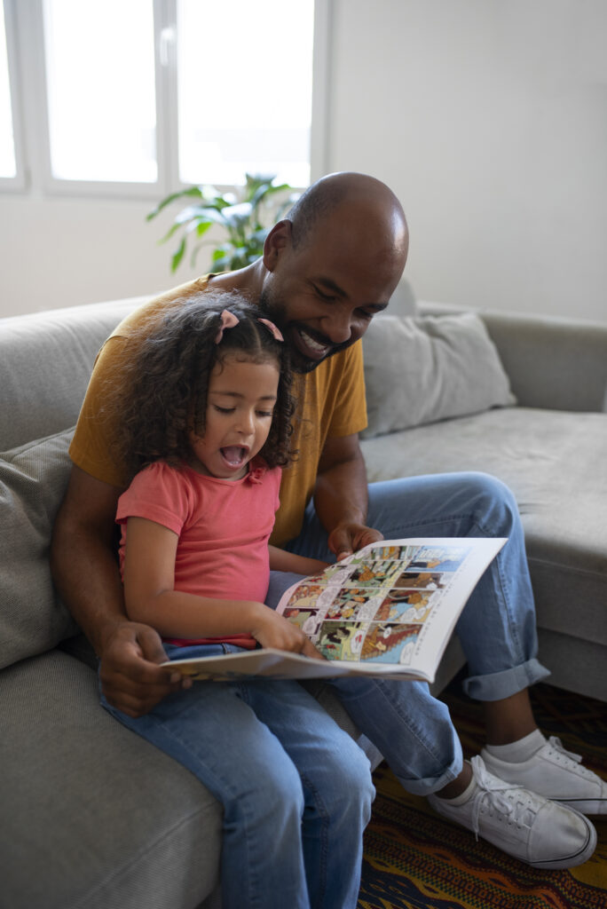 Side View Man Girl Reading Comics Home - Harmony ABA Centers